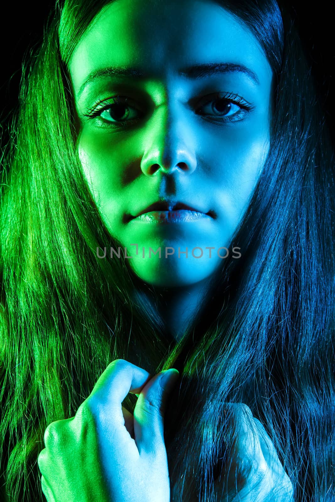 Beautiful young woman in green and blue lights by Artzzz