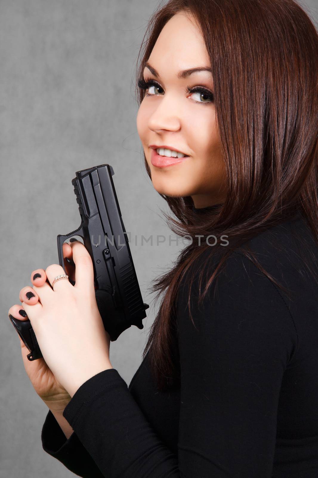 Portrait of a young attractive woman with a gun by Artzzz