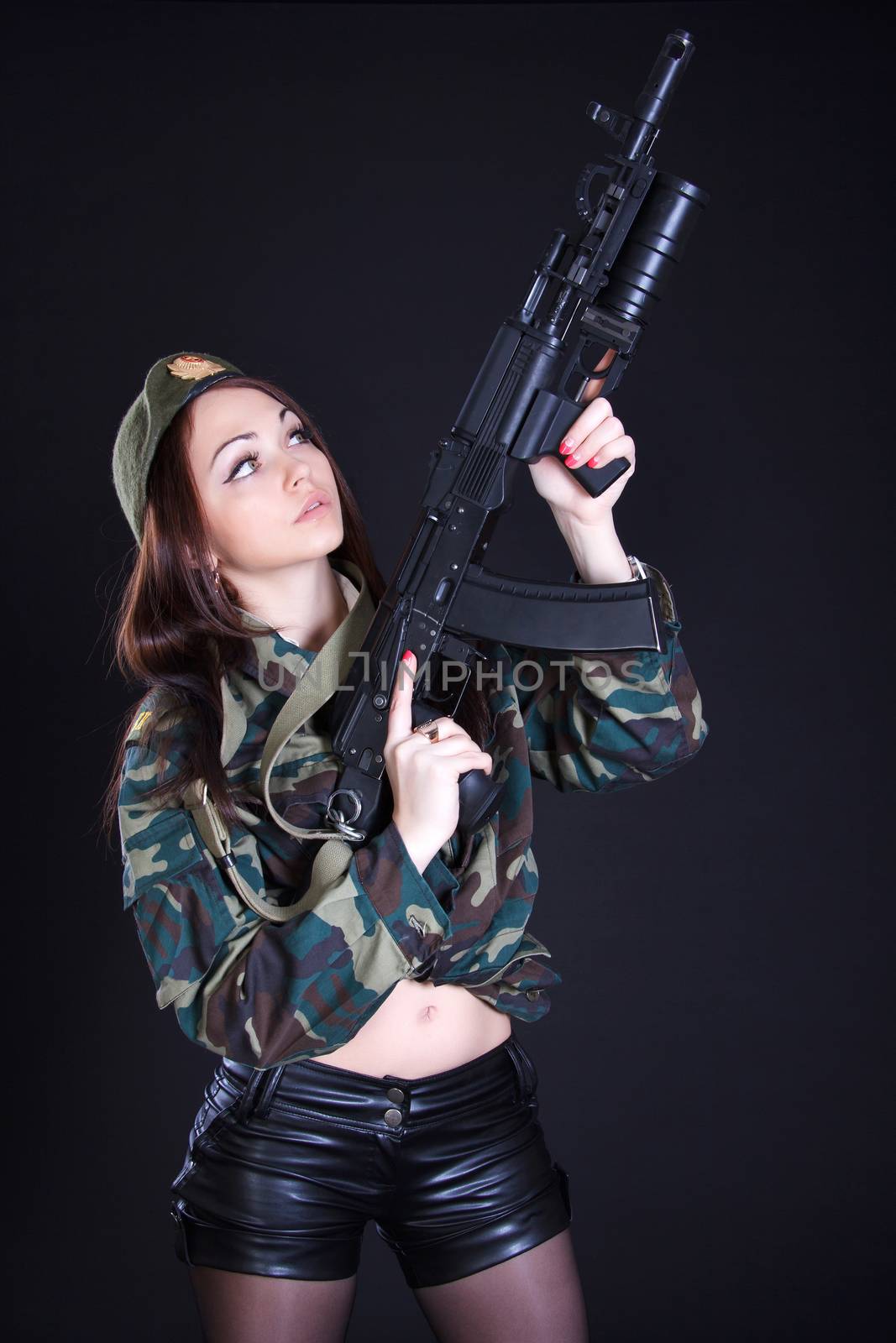 Portrait of a woman in a military uniform with an assault rifle by Artzzz