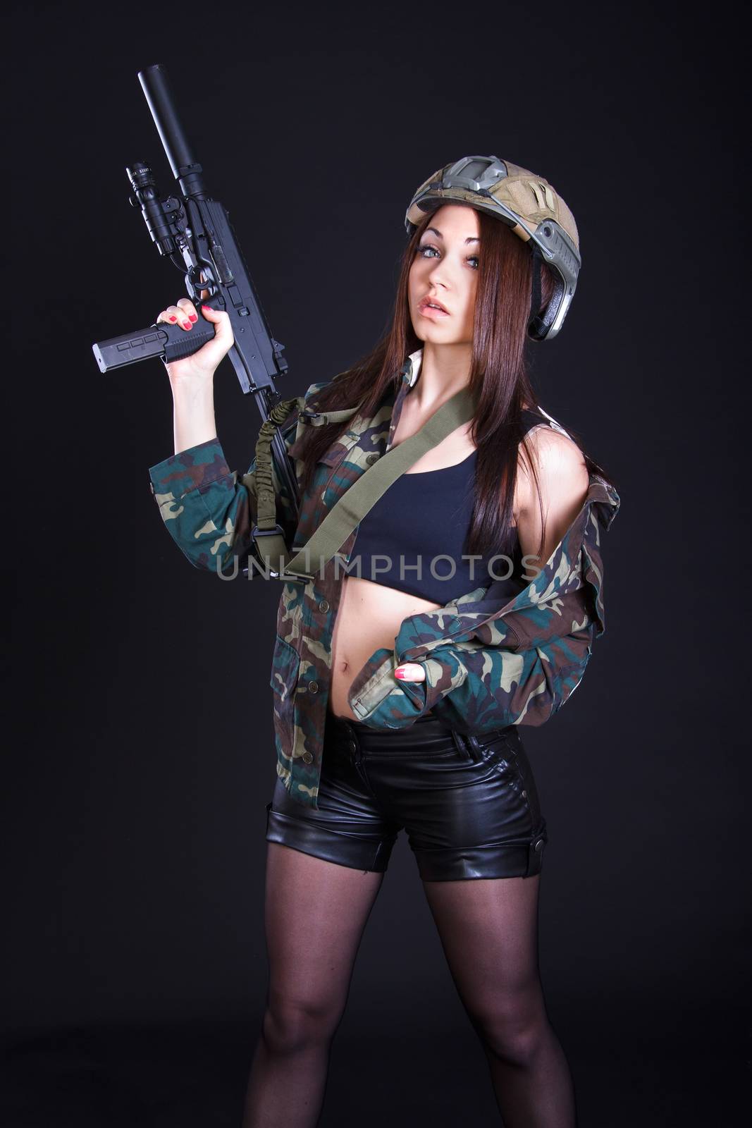 Beautiful young woman in a military uniform with a submachine gu by Artzzz