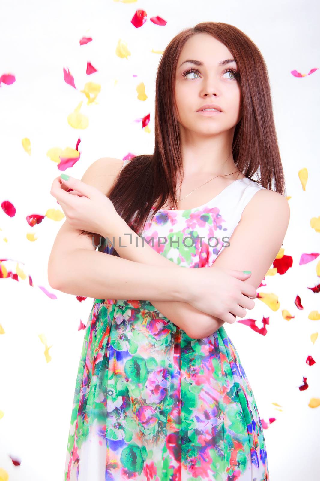 Beautiful young woman in a bright dress over white background