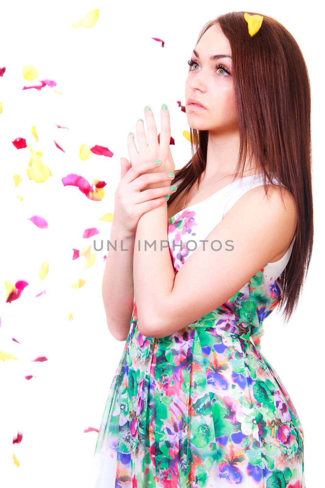 Beautiful young woman in a bright many-colored dress isolated over white background