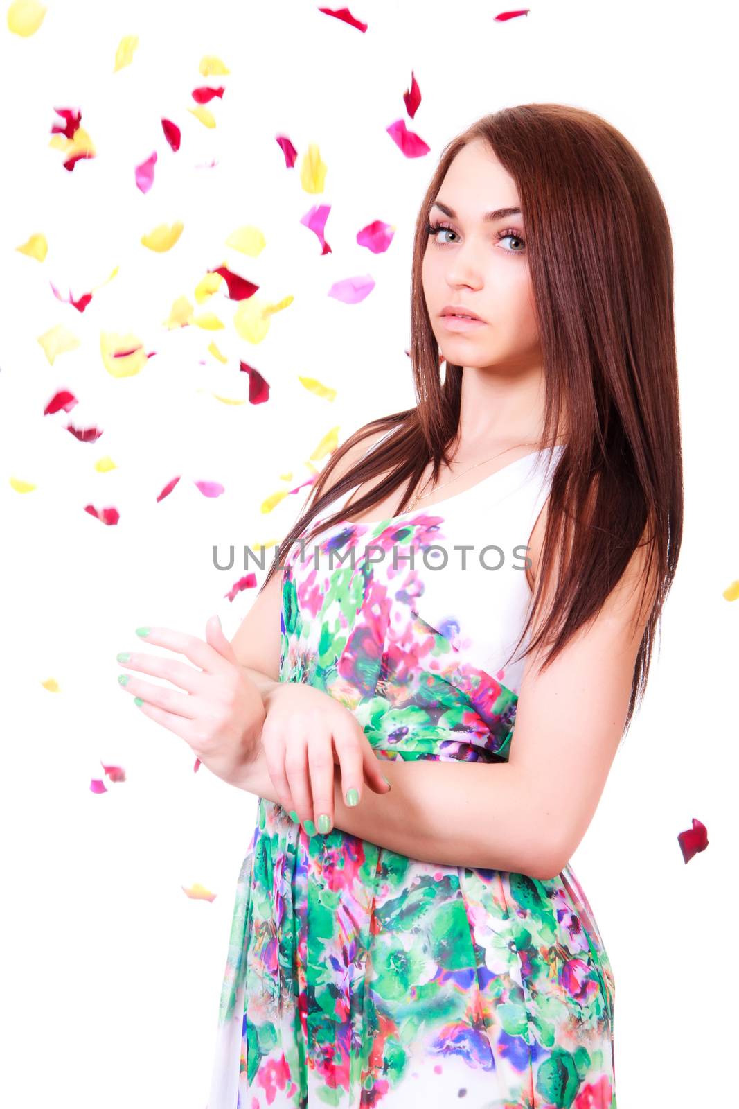 Beautiful young woman in a bright many-colored dress isolated over white background