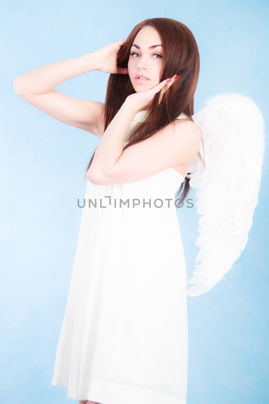 Beautiful young angel over cyan background