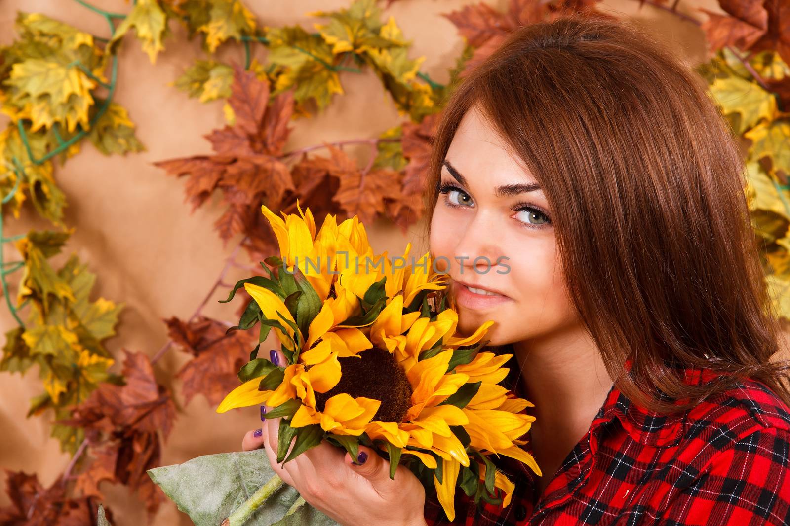 Cute young woman smelling the sunflowers by Artzzz