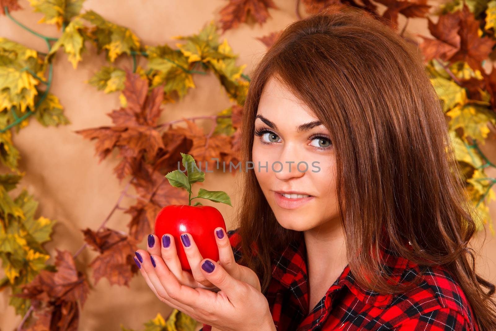Cute young woman holding an apple by Artzzz