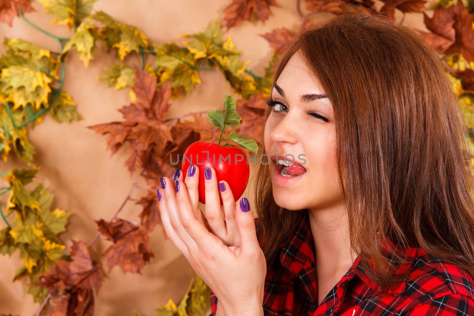 Cute young woman holding an apple by Artzzz