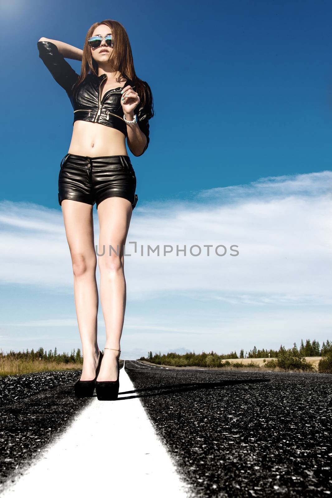 Sexy woman in a black leather clothes on the road by Artzzz