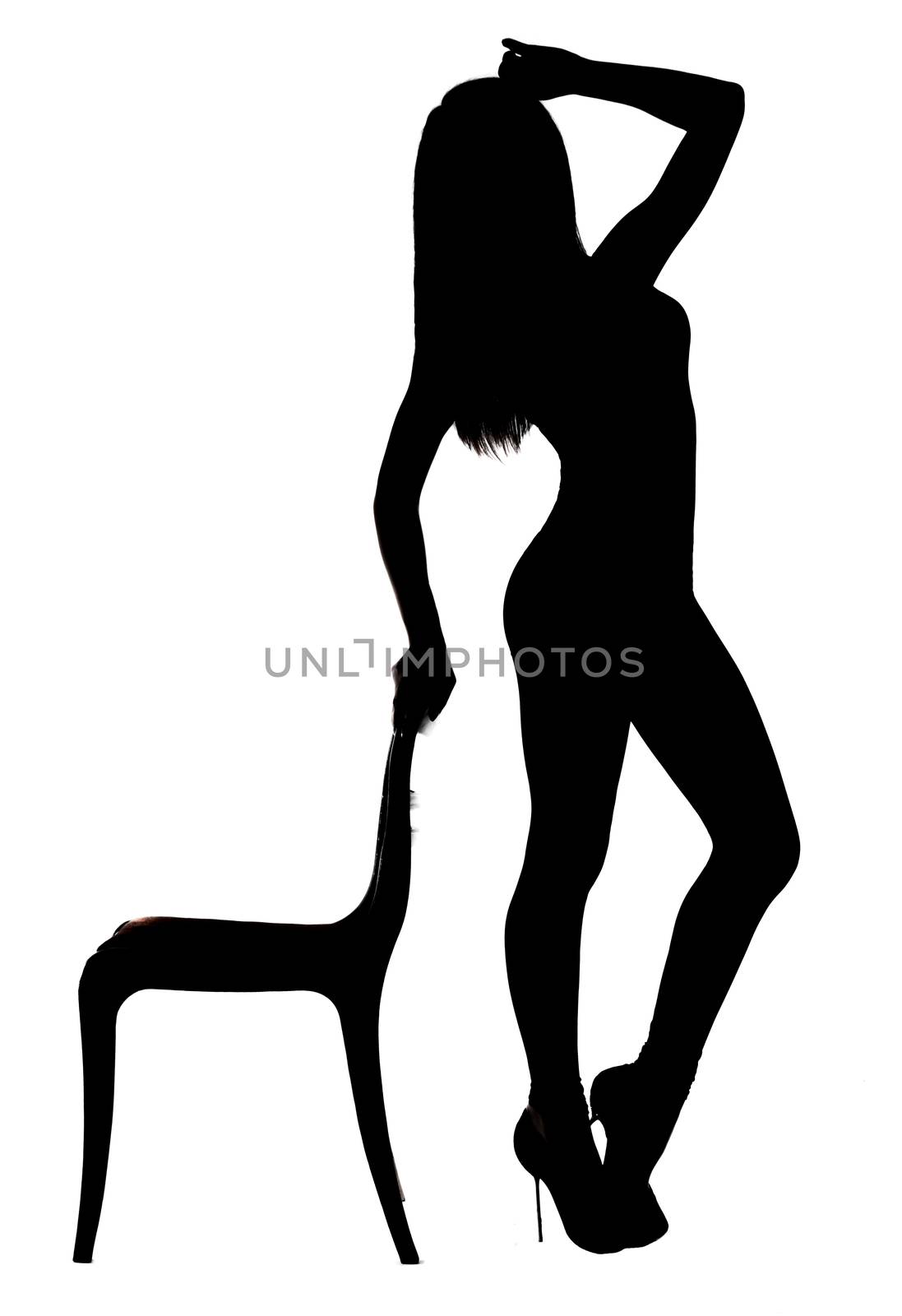 Silhouette of a woman dancing near the chair isolated over white background