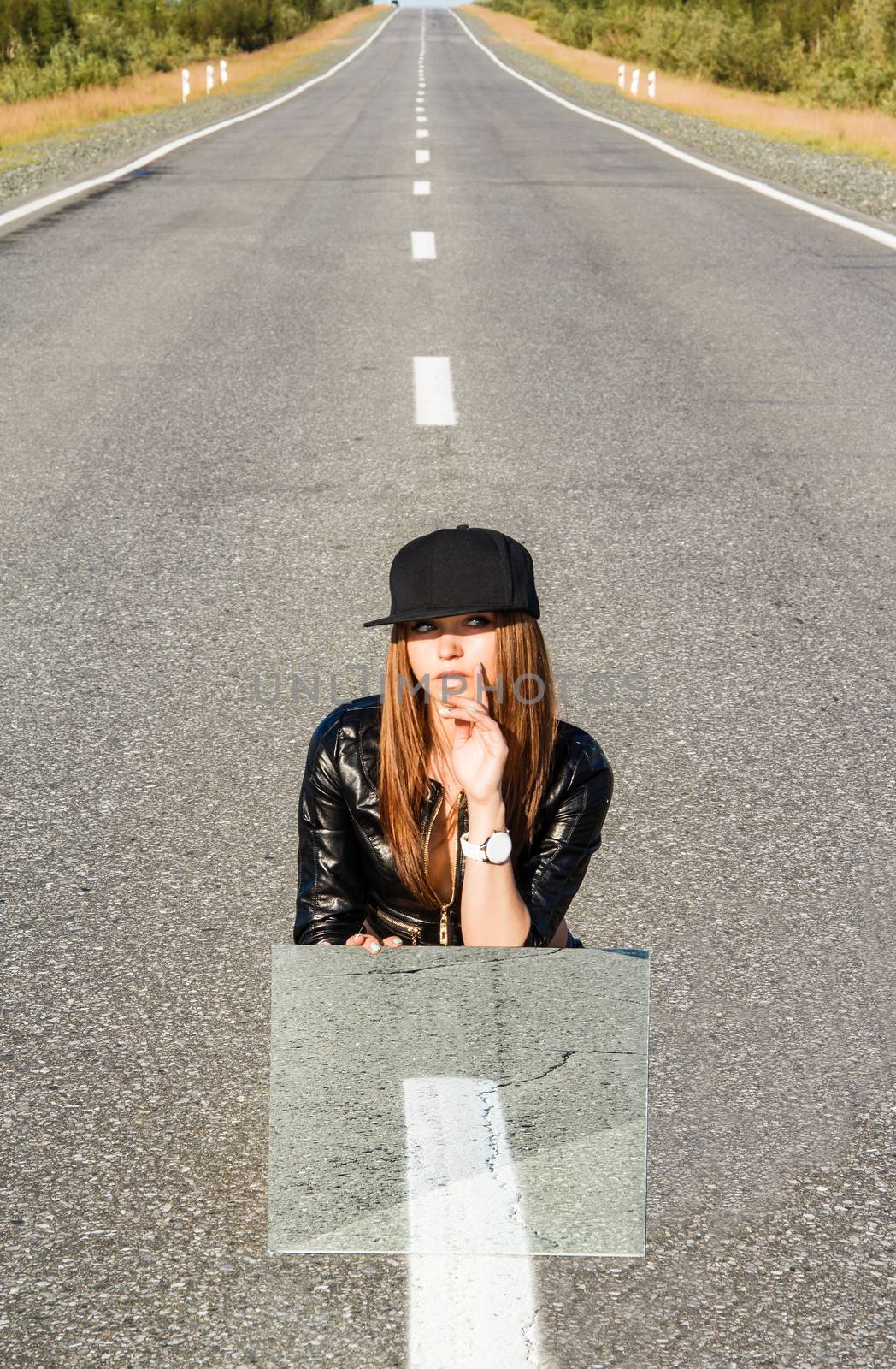 Beautiful young woman sitting on the road by Artzzz