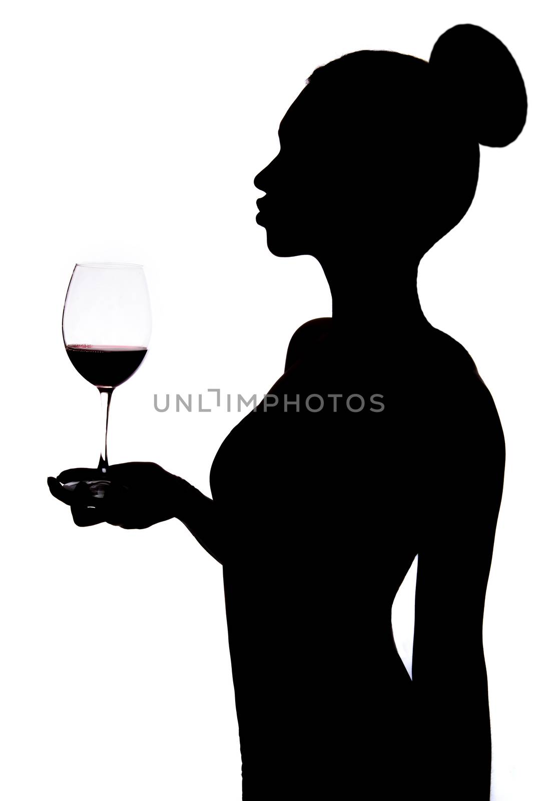 Silhouette of a woman holding the wineglass