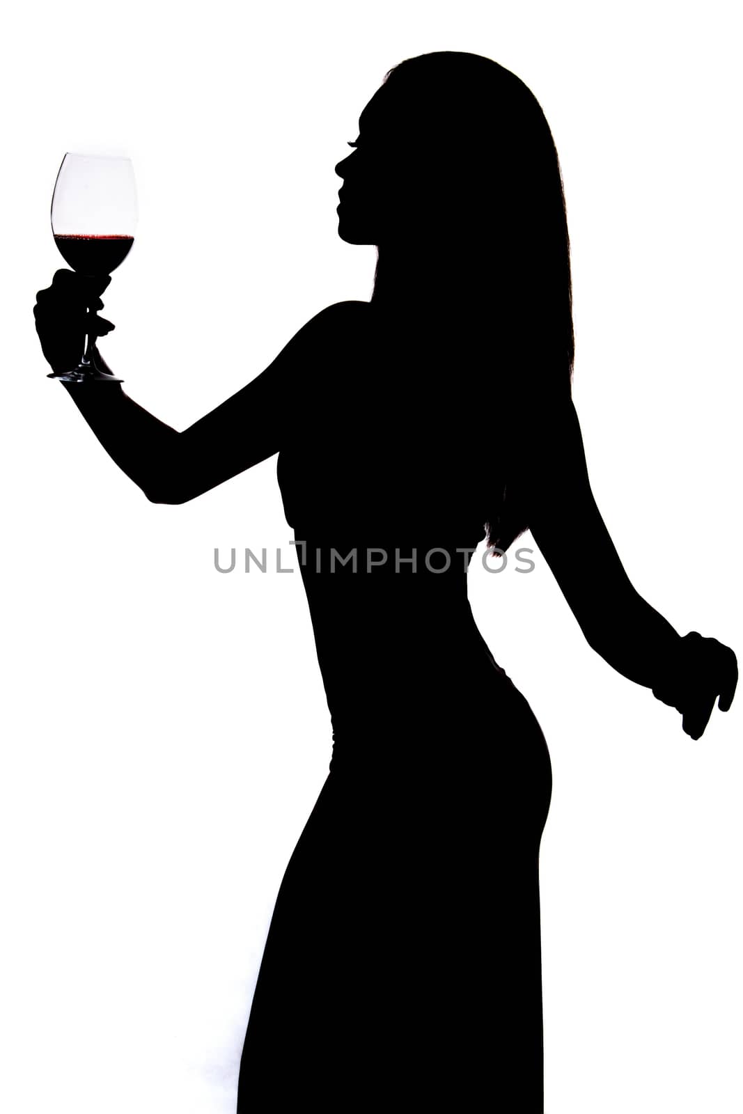 Silhouette of a woman holding the wineglass