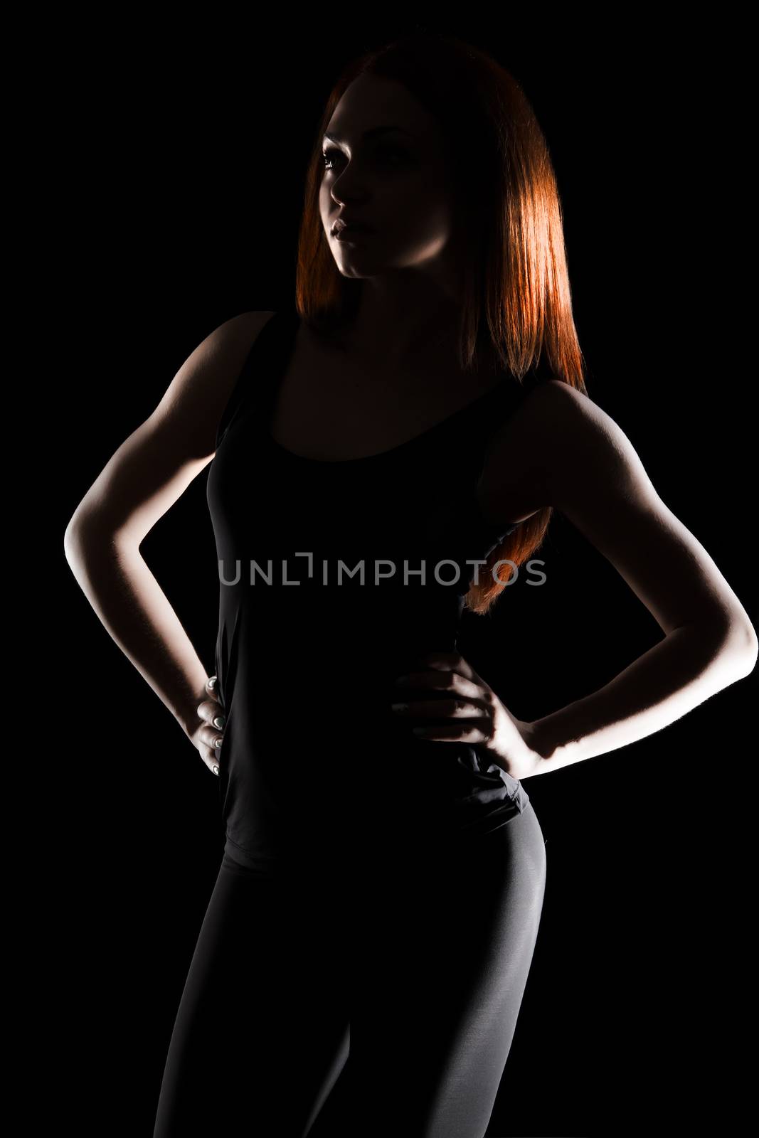 Light contour of a beautiful young woman with a red hair