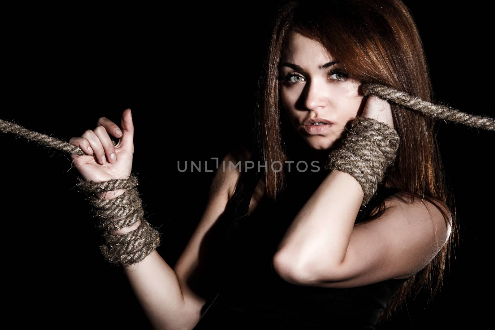 Beautiful young woman with tied arms by Artzzz
