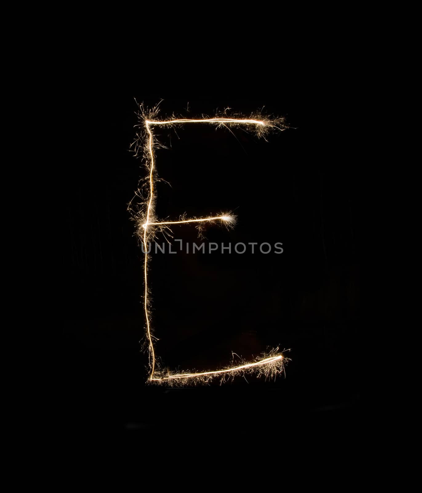 Letter E drew with spakrs on a black background.