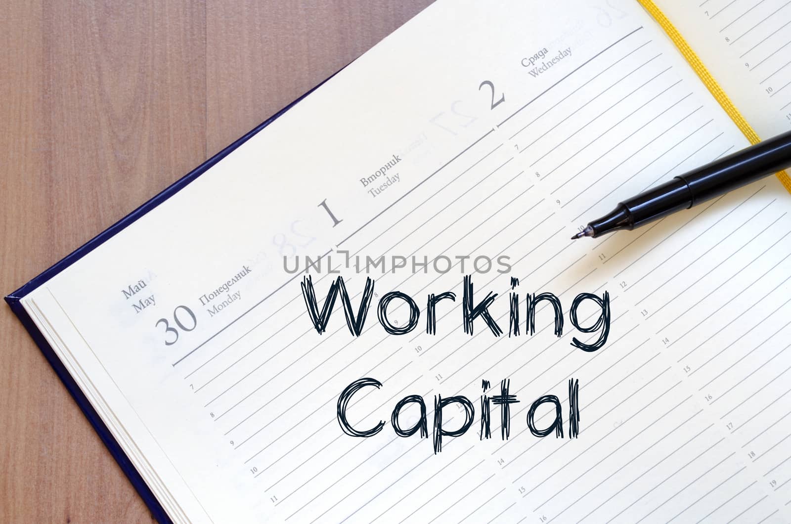 Working capital text concept write on notebook with pen