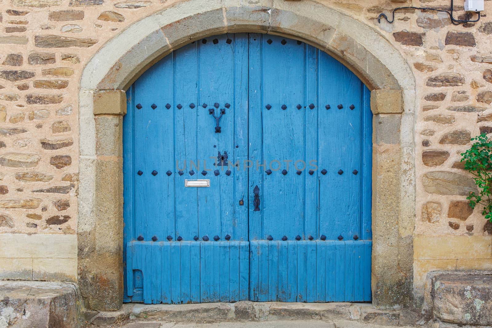 Old rustic wooden door painted in blue 