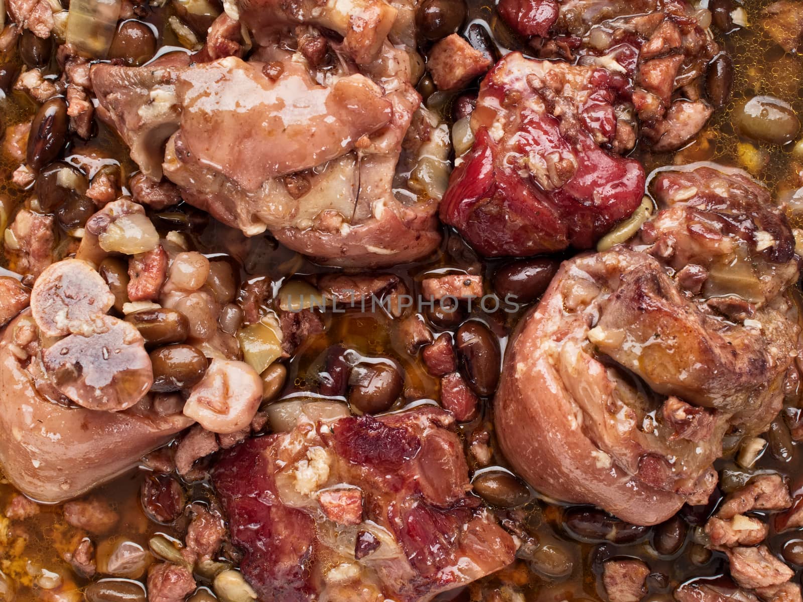 close up of rustic brazilian feijoada pork with black bean stew food background