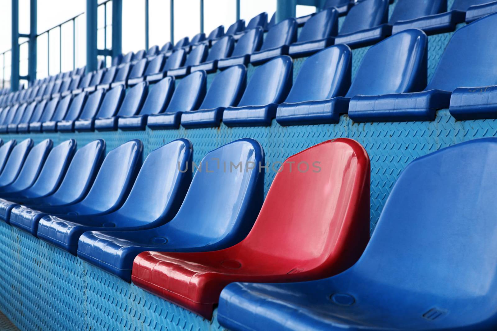 Empty plastic seats at stadium, open door sports arena.