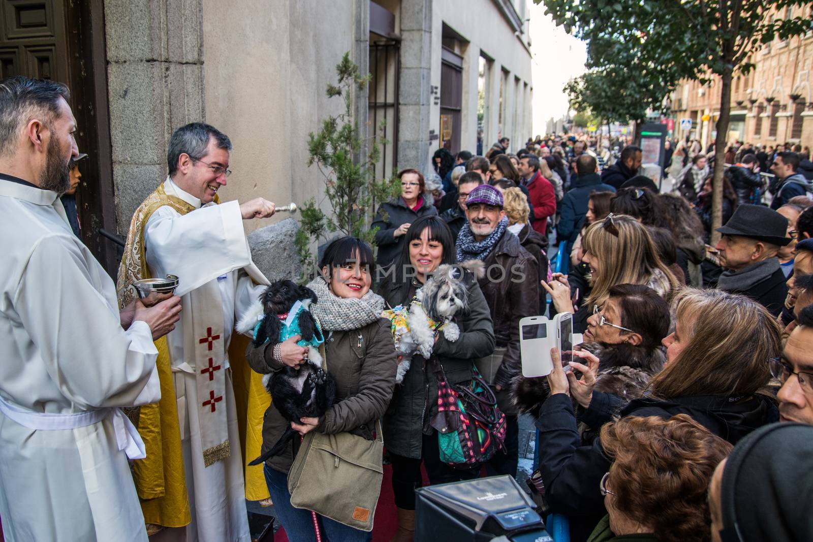 SPAIN, Madrid: Men and women wait in line, holding their pets to be blessed by a priest outside the church of San Antón in Calle de Hortaleza in Madrid on Saint Anthony's day, the patron saint of animals, on January 17, 2016.