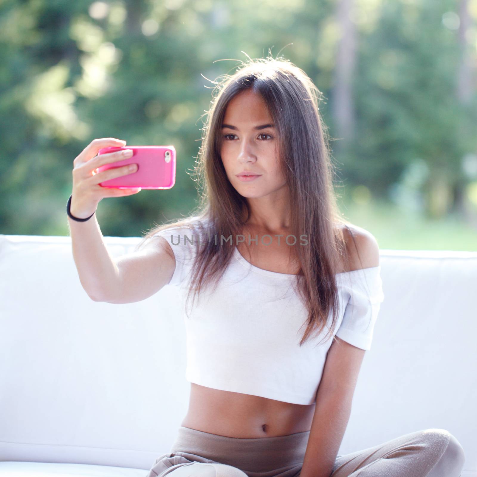 Beautiful young girl take picture with smartphone 