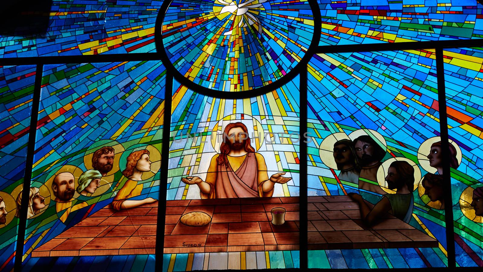 Sorrento, Italy - November 8, 2013: Stained glass window depicting Jesus and the twelve apostles on maundy thursday at the Last Supper in the cathedral