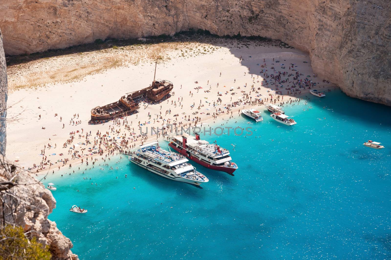 Crowded Navagio Beach on Zakynthos seen from the cliff