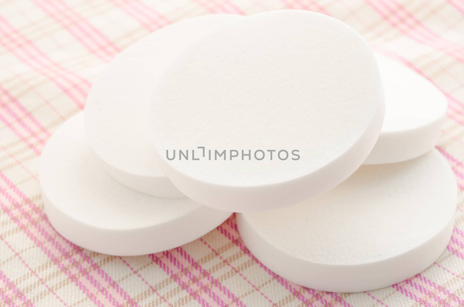 Cosmetic sponges makeup on fabric background