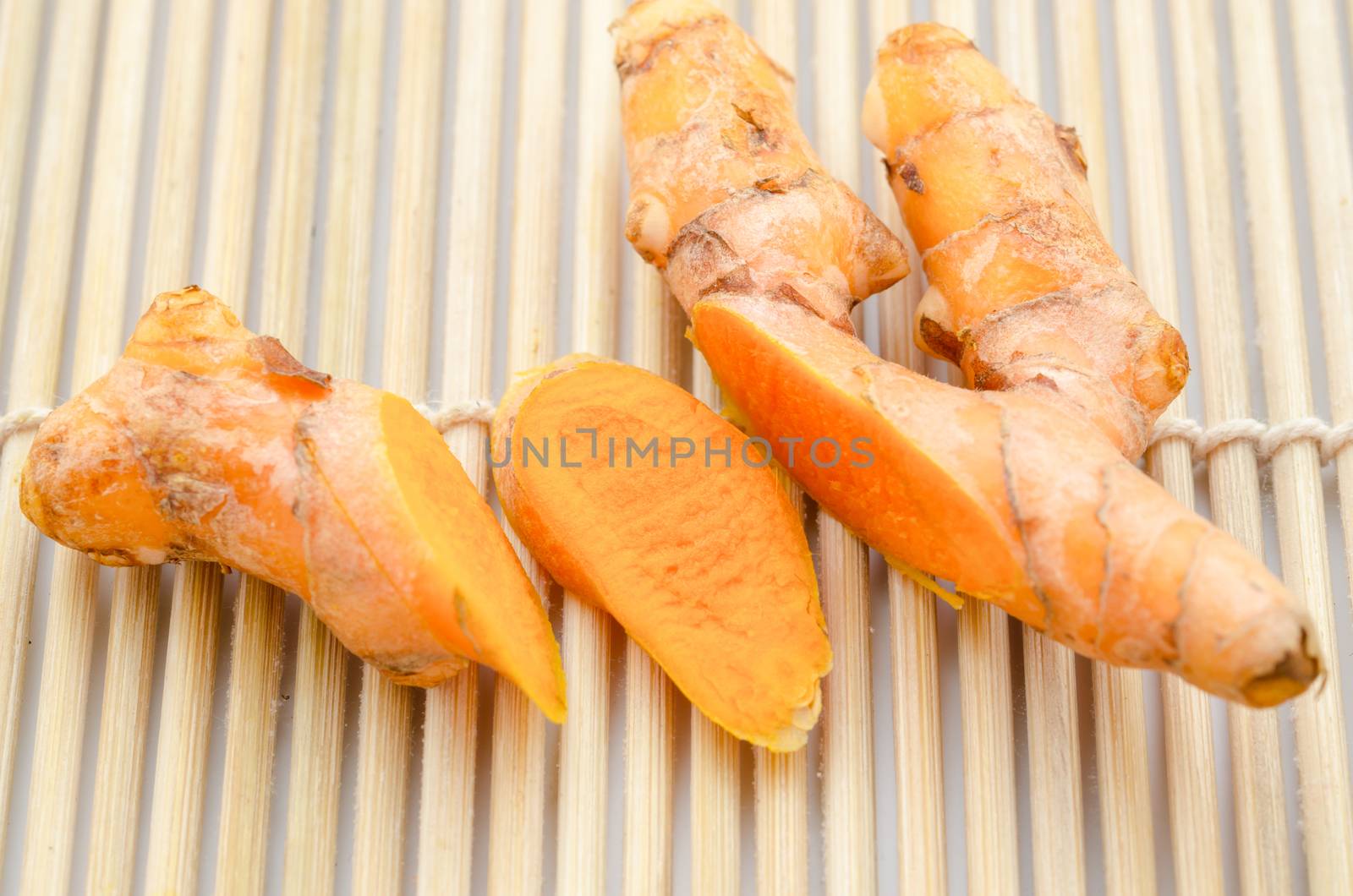 Group of turmeric on grunge mat wooden.