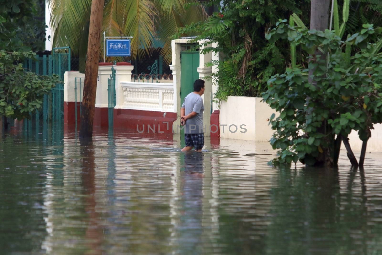 CUBA, La Havana: A man wades through a flooded street in La Havana, Cuba, on January 17, 2016. Heavy seas invaded the Havana coastline along the Malecon seawall. 