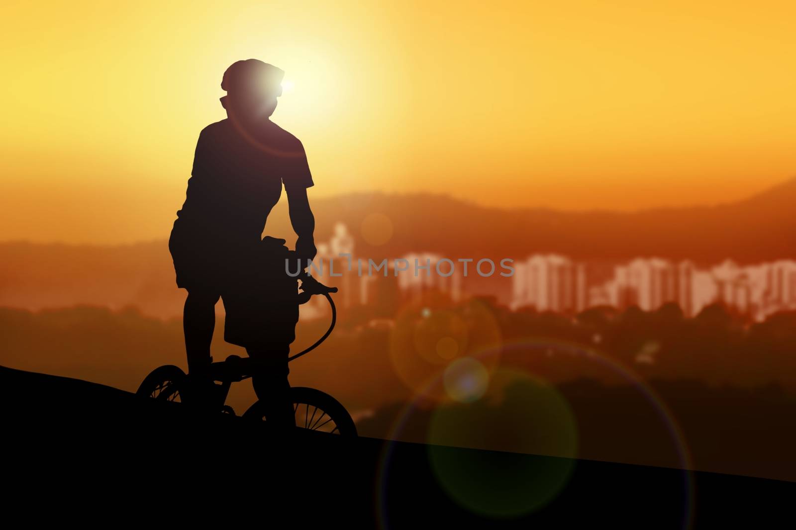 Mountain biker resting while watching sunset