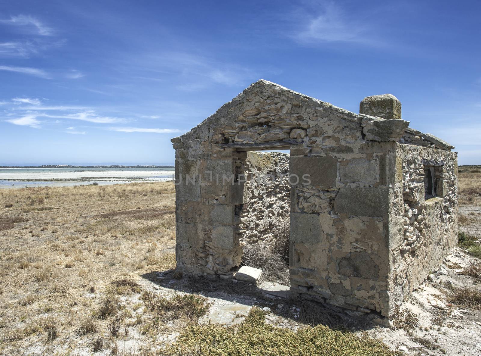 Ruins of a historic house right by the sand of a beautiful beach and wetlands