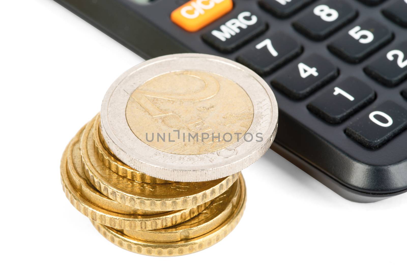 Calculator with stack of coins isolated on white background