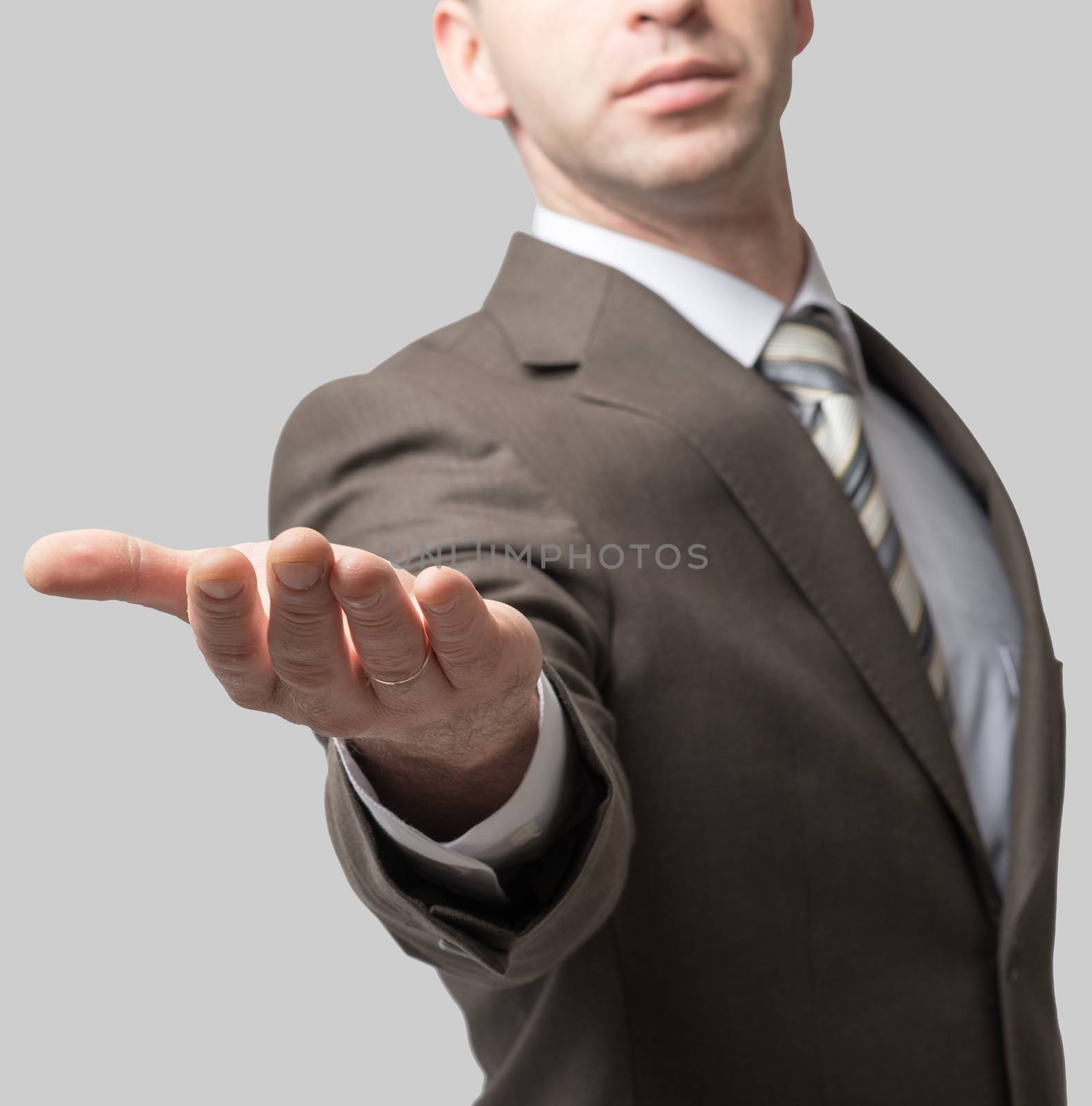 Businessman with outstretched empty right hand, close up view