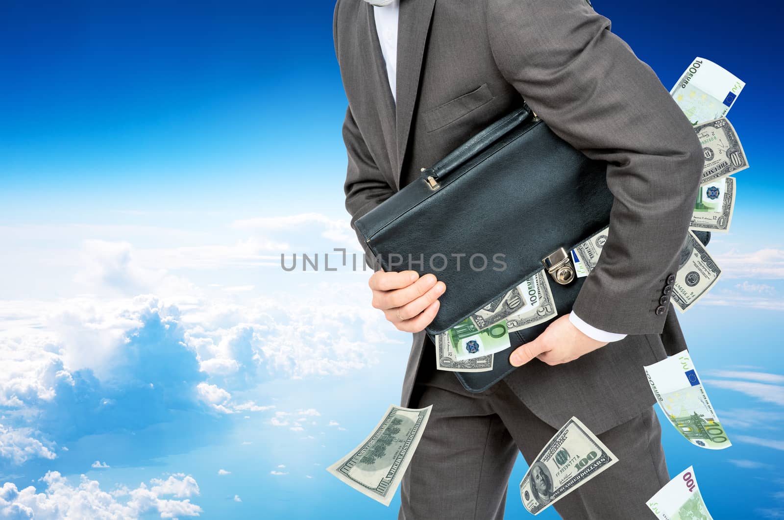 Businessman with suitcase full of money in sky