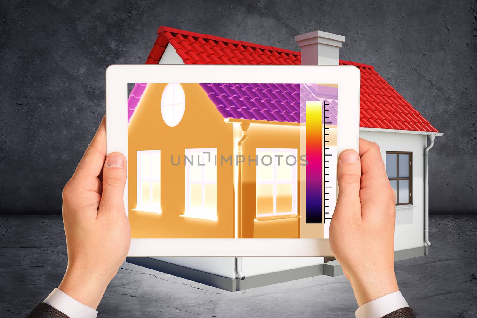 Hands holding tablet in front of house on abstract grey background