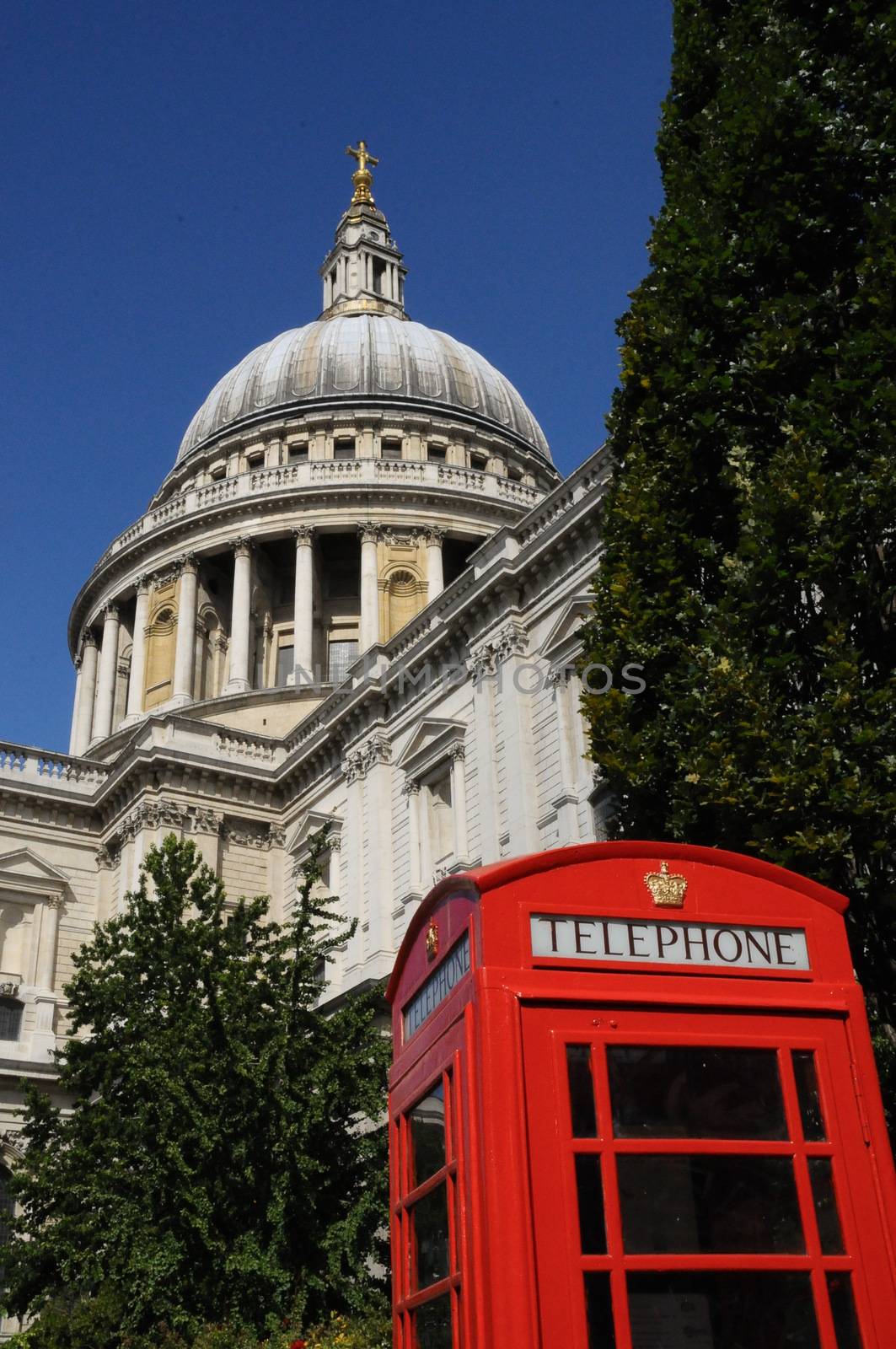 Red telephone box with St Pauls cathedral dome in the background