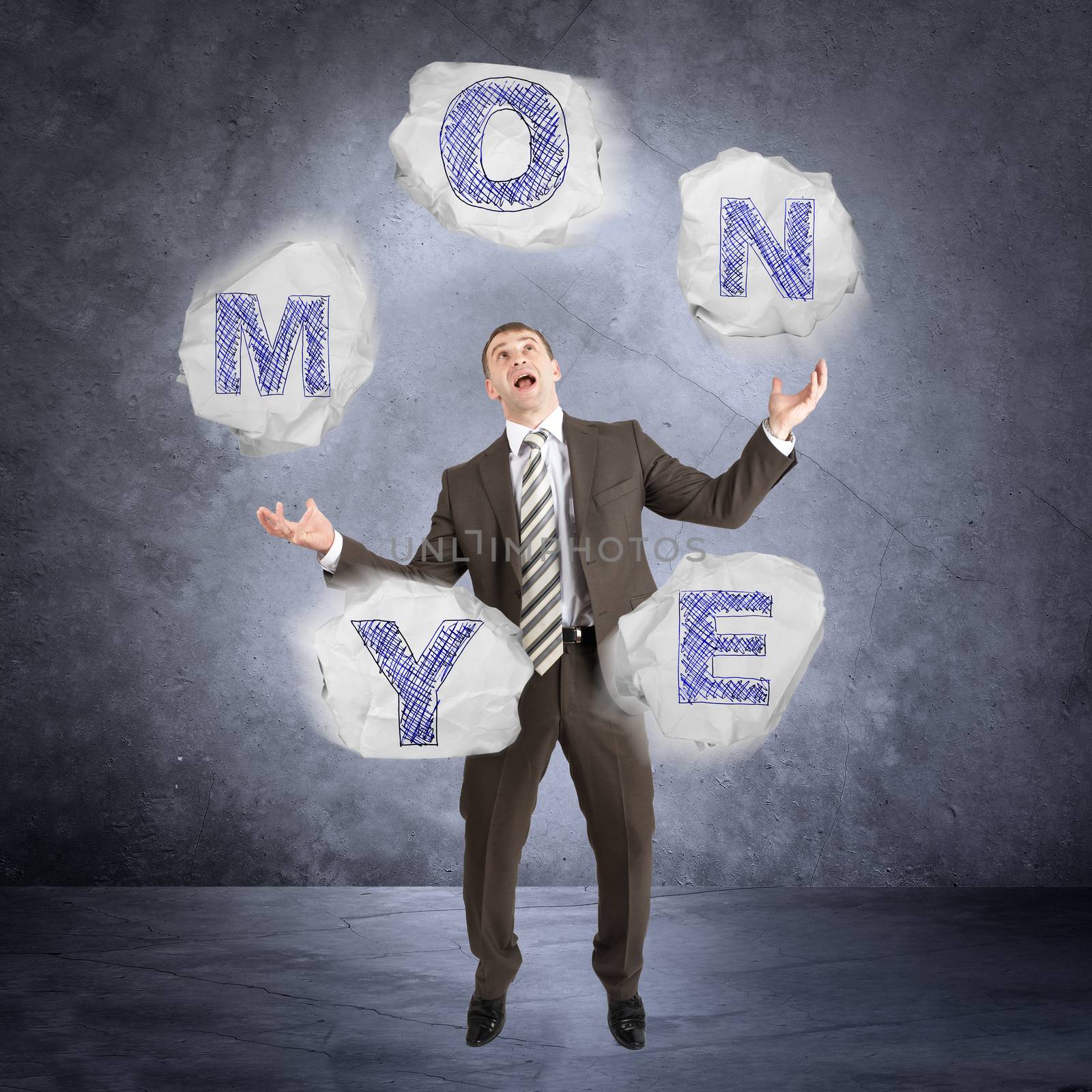 Businessman juggling word money on abstract grey background