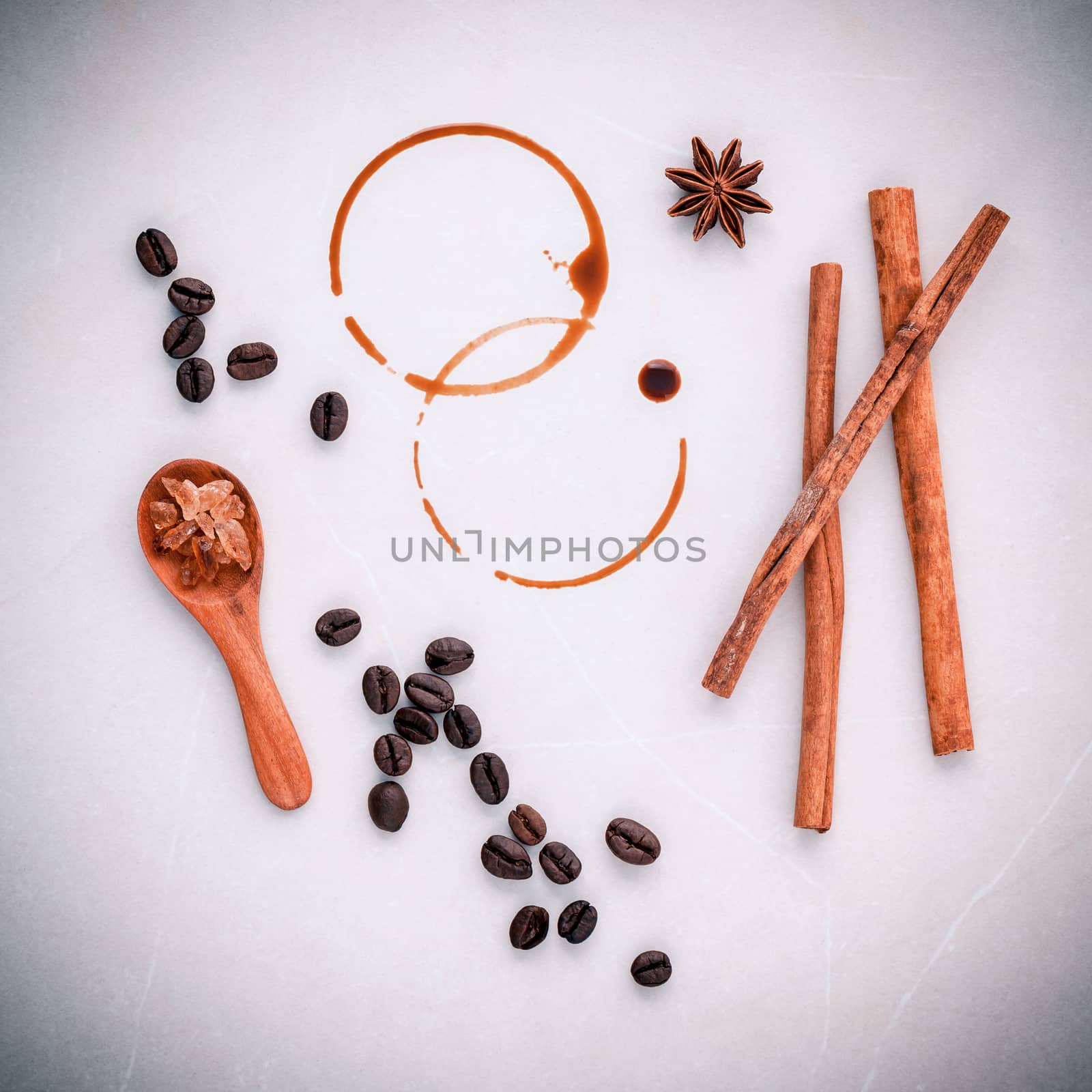 Coffee rings and Coffee beans,star anise ,cinnamon and brown sugar setup on table for menu design.