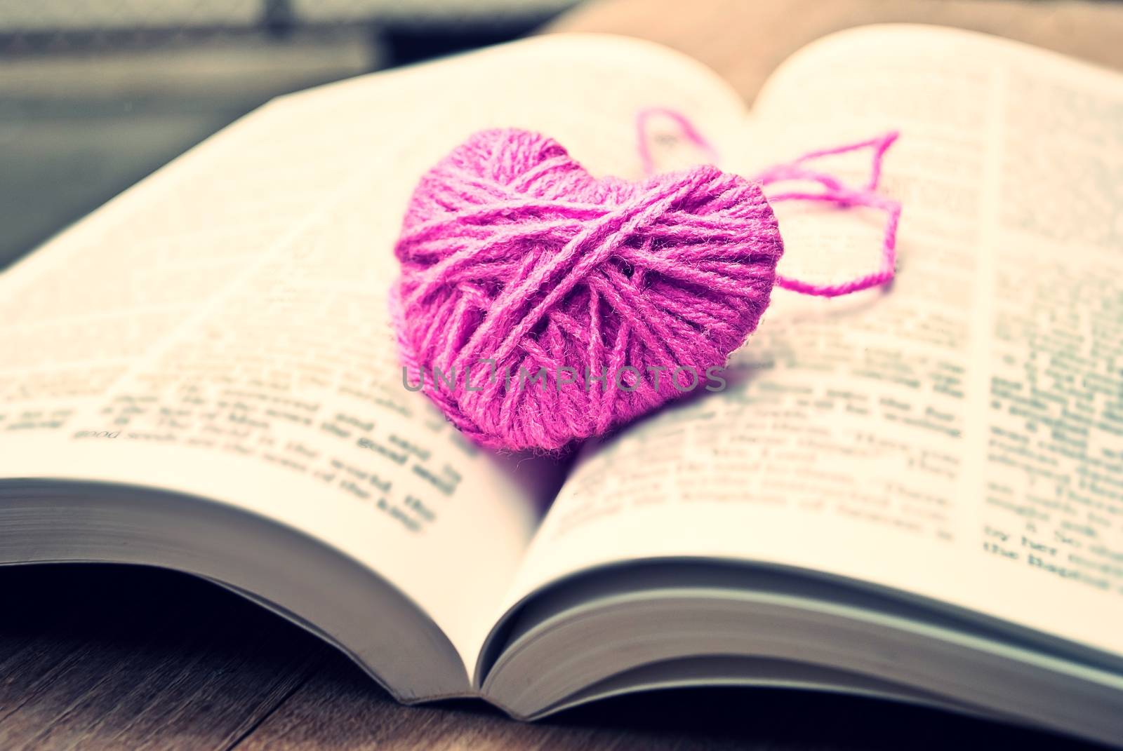 pink heart knitting wool put on the book, for valentine's day