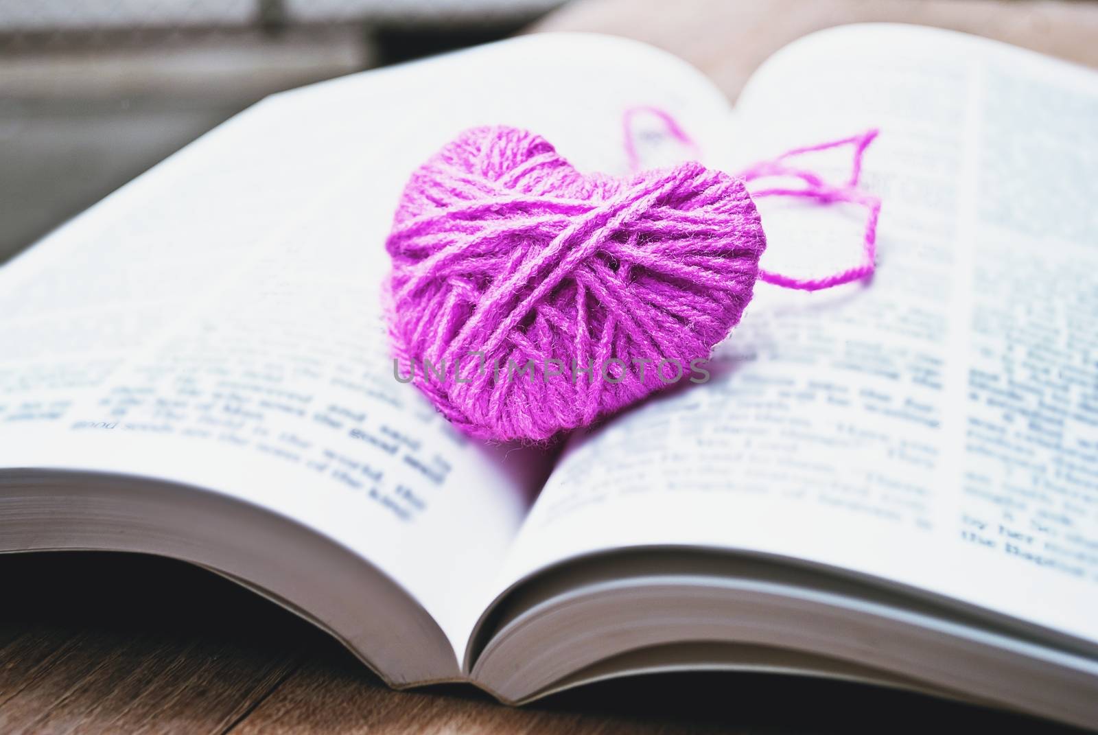 pink heart knitting wool put on the book, for valentine's day