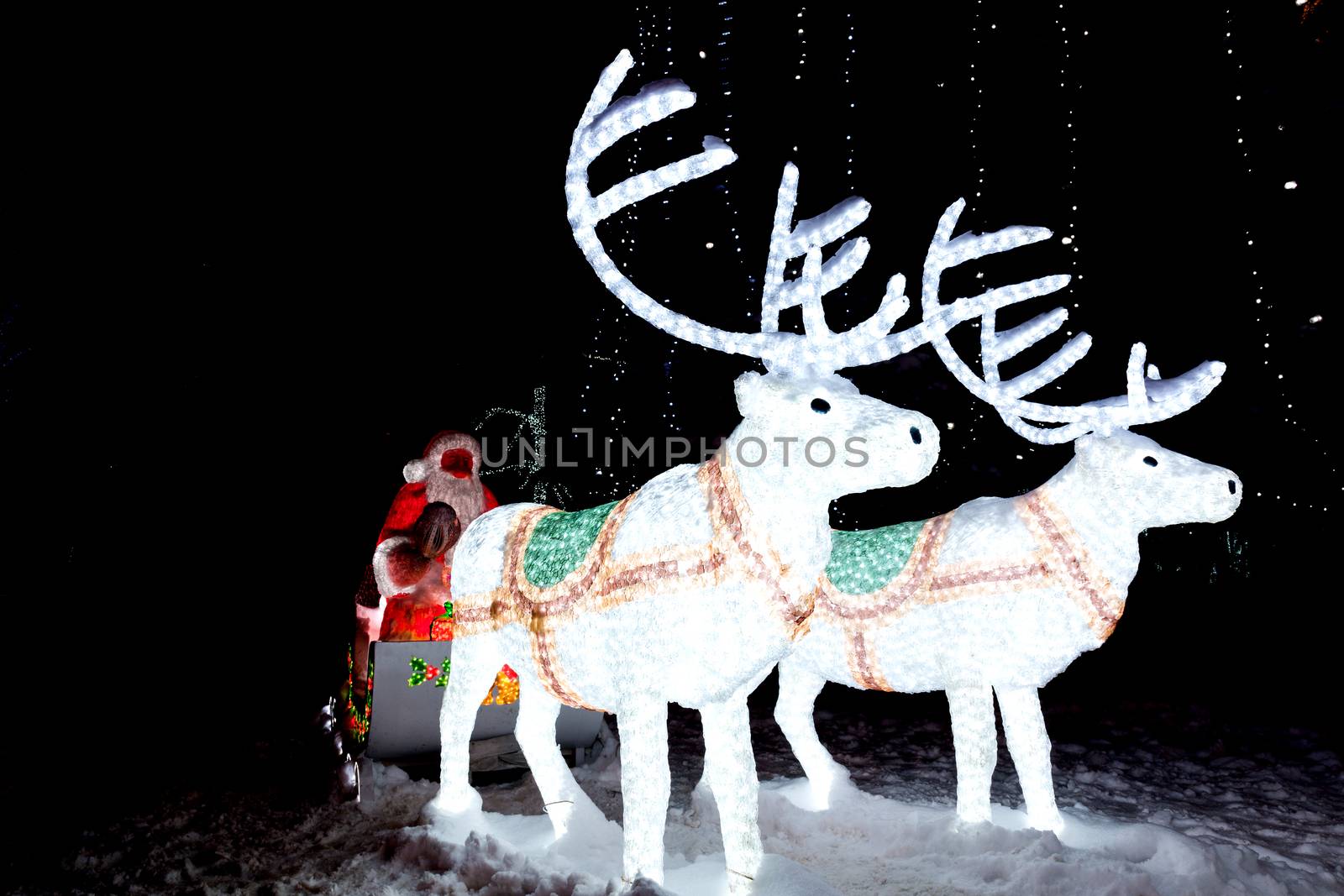 The photograph depicts Santa Claus in a sleigh