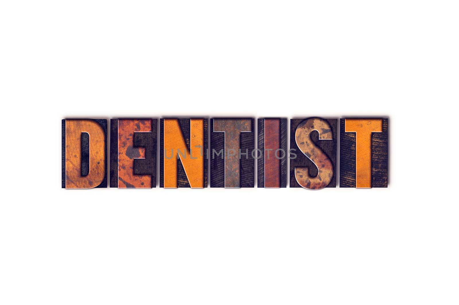 The word "Dentist" written in isolated vintage wooden letterpress type on a white background.