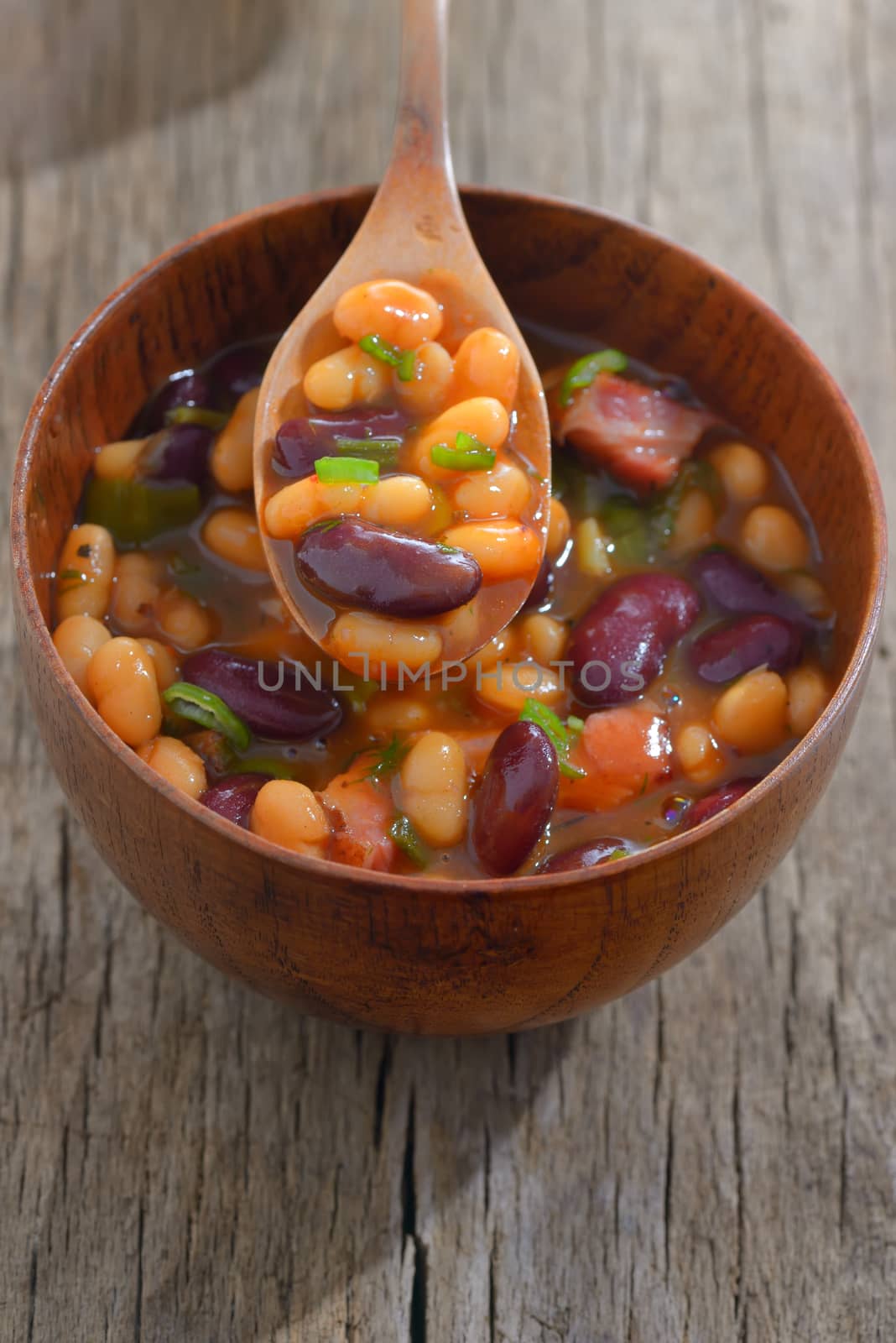 Two types of cooked beans on wooden table