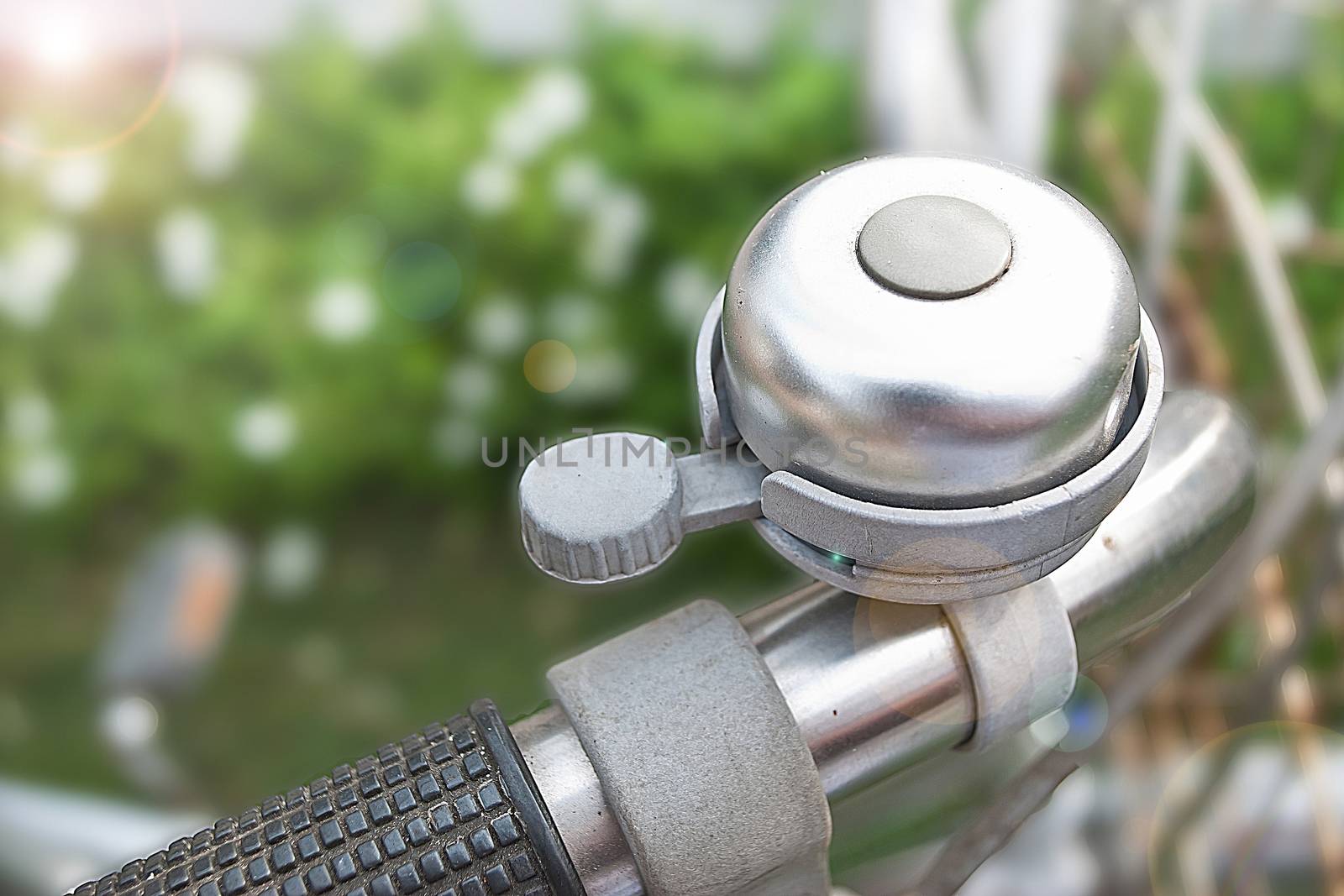 old bicycle bell on blur background (adding lighting len flare from upper right hand corner)