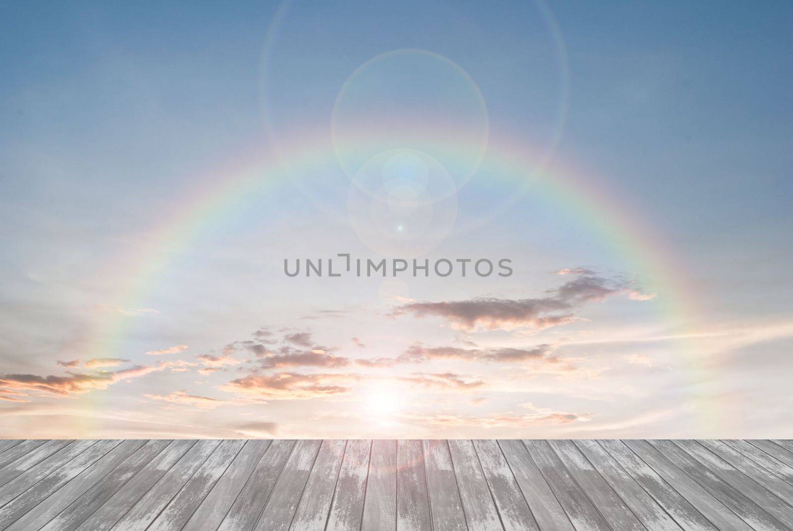 old wooden texture and rainbow  with lens flare in blue sky background