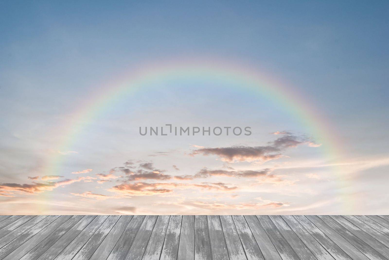 old wooden texture and rainbow in blue sky background