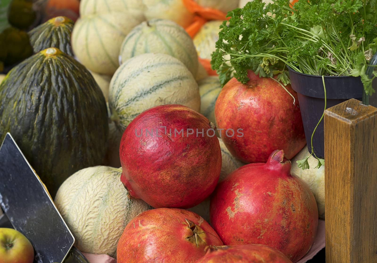 Fresh healthy organic produce pomegranates, cantaloupe, parsley 