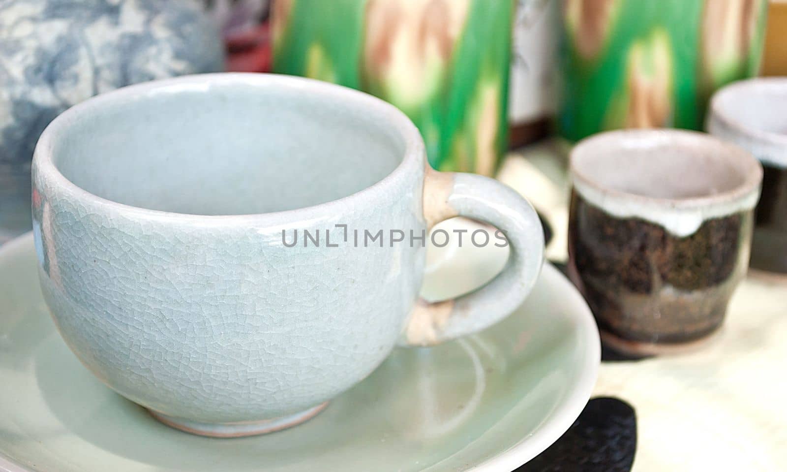 enamel plates, bowls and mugs stacked