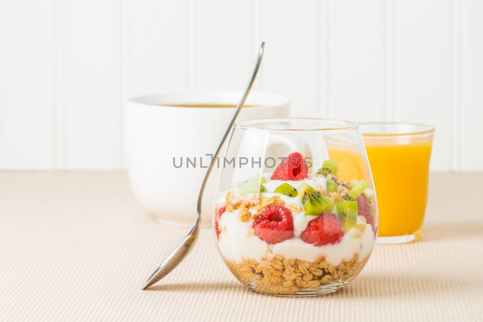 Delicious fruit and yogurt parfait served with coffee and juice.